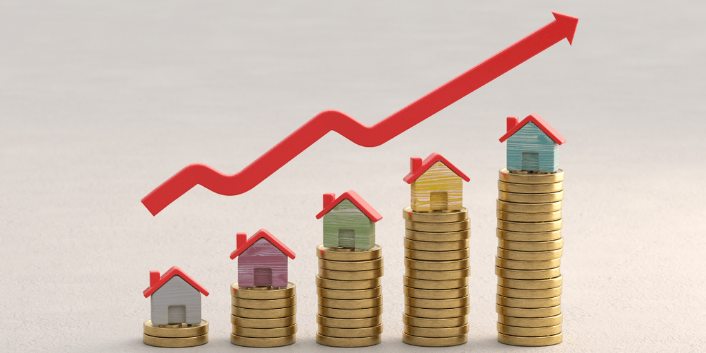 Colorful model houses on stacks of coins beneath an upward arrow representing rising housing market growth.