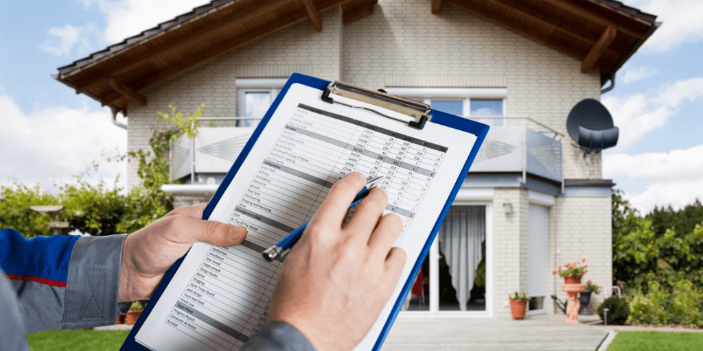 Person holding a clipboard with a checklist in front of a house