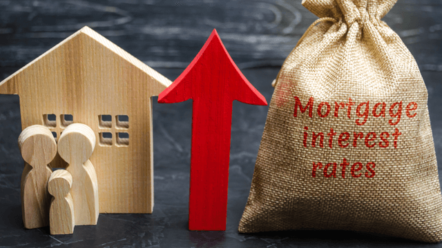 Wooden house, family figures, red arrow up, and burlap bag labeled mortgage interest rates