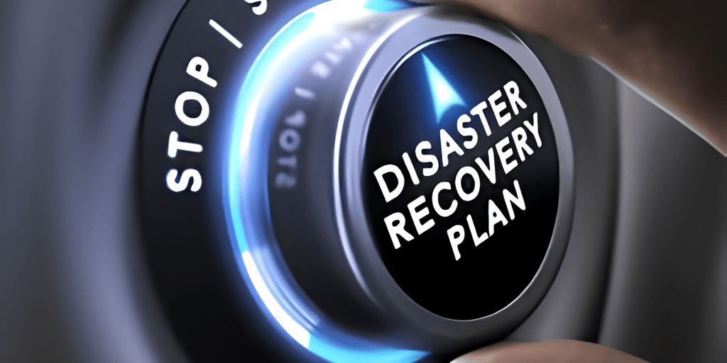 A hand adjusting a dial labeled "DISASTER RECOVERY PLAN" on a control panel