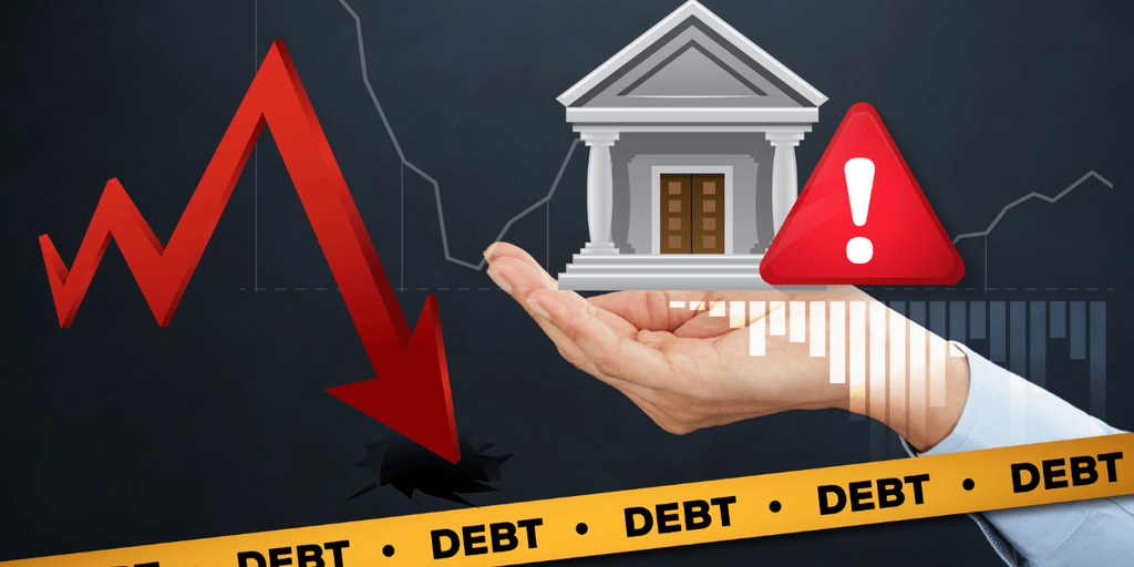 A hand holds a bank icon above a downward red arrow and debt warning signs