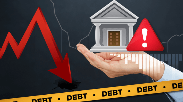 A hand holds a bank icon above a downward red arrow and debt warning signs