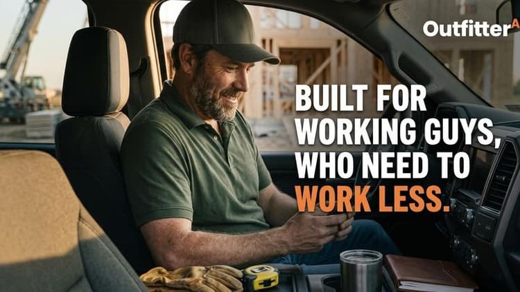 Man in a truck smiles while holding a coffee, with construction in the background