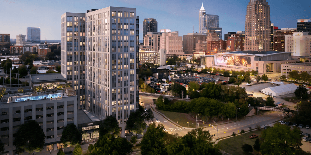 City skyline featuring modern buildings and greenery at dusk in Raleigh, North Carolina