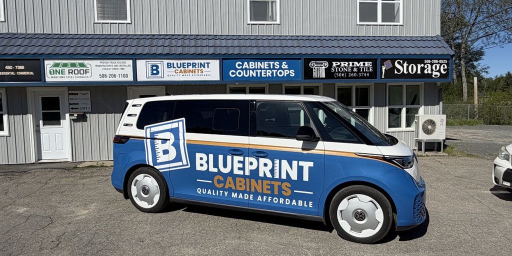 Blueprint Cabinets branded van parked outside cabinetry and countertops showroom in Fredericton.