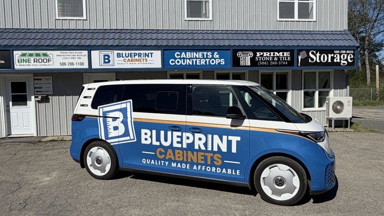 Blueprint Cabinets branded van parked outside cabinetry and countertops showroom in Fredericton.