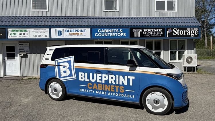 Blueprint Cabinets branded van parked outside cabinetry and countertops showroom in Fredericton.