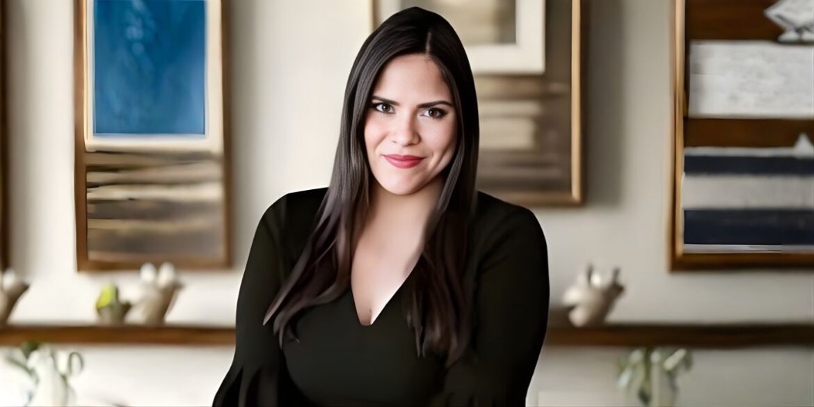 A woman with long dark hair is seated in a calming room, emphasizing the importance of sensory-friendly spaces.